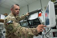 Tech. Sgt. Scott Hatch performs maintenance on a blood testing machine at Bagram Airfield, Afghanistan, Sept. 24, 2015. (U.S. Air Force /Tech. Sgt. Joseph Swafford)