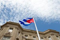 The Cuban flag is raised over their new embassy in Washington, Monday, July 20, 2015. (AP Photo/Andrew Harnik, Pool)