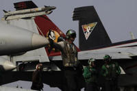 Caption: Sailors work on the flight deck of the U.S. Navy aircraft carrier USS George H.W. Bush on Sunday, Aug. 10, 2014 in the Persian Gulf. (AP Photo/Hasan Jamali)