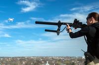 A woman test shoots the anti-drone gun known as the DroneDefender. (Photo courtesy Battelle)