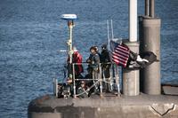 Cmdr. Melvin Smith, commanding officer of the Seawolf-class submarine USS Jimmy Carter (SSN 23), looks on as the submarine transits the Hood Canal on its way home to Naval Base Kitsap-Bangor. (U.S. Navy/Lt. Cmdr. Michael Smith)
