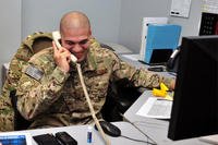Airman 1st Class Frank Perez-Castillo smiles during a surprise phone call from Chief Master Sgt. of the Air Force James A. Cody Dec. 24, 2014, at Bagram Airfield, Afghanistan. (U.S. Air Force photo/Staff Sgt. Whitney Amstutz)