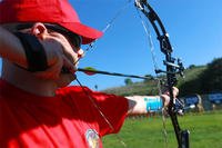 Marine Sgt. Jeremy Anderson, an athlete from Wounded Warrior Battalion – East, takes aim with his bow during archery practice at the 2015 Marine Corps Trials. Marine Corps photo by Cpl. Jared Lingafelt
