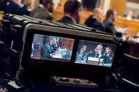 Defense Secretary Ash Carter and Chairman of the Joint Chiefs of Staff Gen. Martin E. Dempsey are shown on video monitors during testimony before the U.S. Senate Committee on Armed Services committee, July 7, 2015. (DoD photo/Army Staff Sgt. Sean K. Harp)