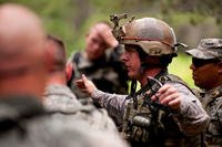 Master Sgt. Brandon Herber, a member of the 122nd Security Forces Squadron from the 122nd Fighter Wing, Fort Wayne, Ind., explains proper tactics to a squad of Airmen during an ambush exercise, July 29, 2015. (Photo by Staff Sgt. William Hopper)