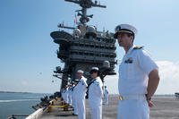 A lieutenant mans the rails aboard the aircraft carrier USS Harry S. Truman (CVN 75) as it returns to homeport at Naval Station Norfolk, completing an 8-month deployment to the U.S. 5th and 6th Fleet areas of operations. (U.S. Navy/MC3 Adelola Tinubu)
