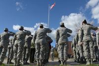 Airmen salute the American flag as it is lowered during the women’s retreat ceremony at Ellsworth Air Force Base, S.D., April 7, 2016. (U.S. Air Force/Airman Donald C. Knechtel/Released)