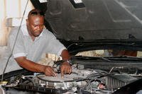 man looking under car hood