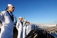 Sailors man the rails aboard the USS Ronald Reagan