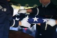 Airmen from the honor guard at Eglin Air Force Base, Florida, finish folding a flag during a memorial service Jan. 22, 2011. (U.S. Air Force photo/Joshua Green)