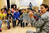 Senior Airman Ana Gomez-Martinez, 39th Medical Operations Squadron oral preventative technician, reads a book about dental health to children at Incirlik Unit School Feb. 19, 2016, at Incirlik Air Base, Turkey. (Photo by Jack Sanders/U.S. Air Force)