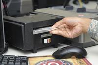 Airman 1st Class Lakeisha Cohn, a customer support technician with the 6th Force Support Squadron, creates a dependent ID on Nov. 10, 2016, at MacDill Air Force Base, Fla. Airman 1st Class Mariette Adams/Air Force