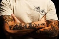Senior Airman DelAngel, 432nd Wing administration journeyman, displays his tattoos at Creech Air Force Base, Nev.