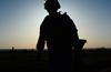 The silhouette of a soldier as he runs to the turnaround point of a 12 mile ruck march. 