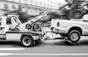 Pickup truck being towed by tow truck