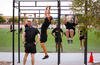 Soldiers perform pull-ups during physical training.