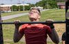 A U.S. Marine with Fleet Marine Force, Atlantic, Marine Forces Command, Marine Forces Northern Command, performs a pull-up during the Murph Challenge at Camp Elmore, Norfolk, Virginia.