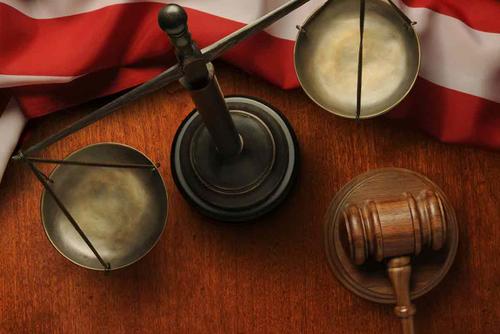 Gavel and American flag with scales of justice.