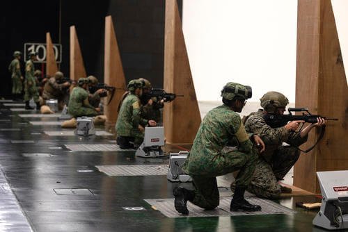 Singapore Army soldiers observe U.S. Marines firing Singaporean Assault Rifle 21 service rifles on a 100-meter range during Exercise Valiant Mark 2022 on Pasir Laba Camp, Singapore.