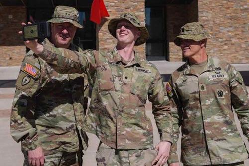 Spc. Christian Sutton takes photos with 1st Armored Division's leadership