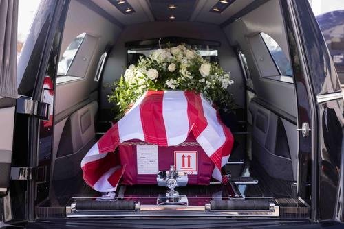 The casket of Cedric Charlie Hamm, a U.S. Army veteran and Texas native killed fighting for Ukraine, is loaded into a hearse at Dallas Fort Worth International Airport.