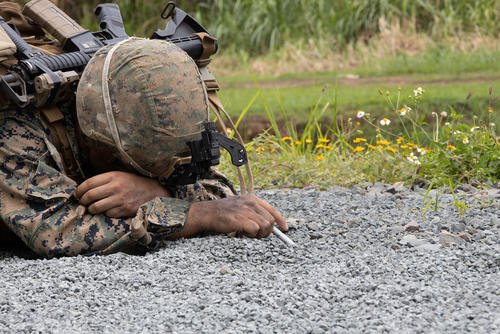 U.S. Marine Corps Lance Cpl. Ian Acosta probes for a mine on a clearance patrol during a field exercise (FEX) at Marine Corps Training Area Bellows, Waimanalo, Hawaii.