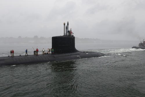 The Virginia-class attack submarine USS South Dakota (SSN 790) is led by the tug John P. Wronowski in a transit of the Thames River to the submarine’s homeport of Naval Submarine Base New London.