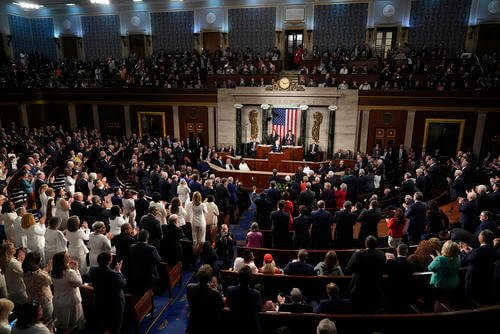 Democrats and Republicans stand to applaud as President Joe Biden speaks about former Rep. John Lewis as he delivers the 2024 State of the Union address to a joint session of Congress at the U.S. Capitol in Washington.