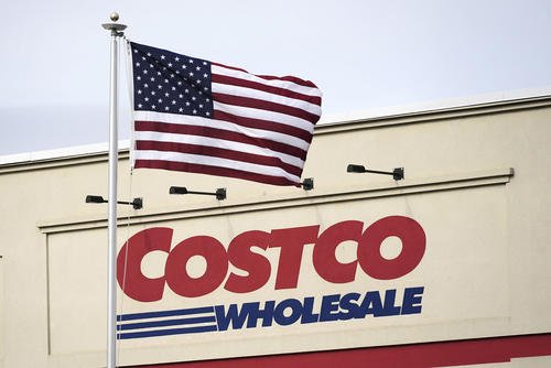 An American flag flies outside a Costco Warehouse in Cranberry, Pa.