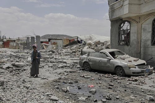 Yemeni soldier inspects the damage reportedly caused by U.S. airstrikes in Yemen