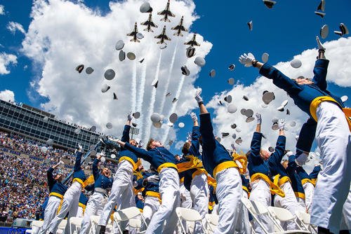 The U.S. Air Force Academy Class of 2024 graduates toss their hats