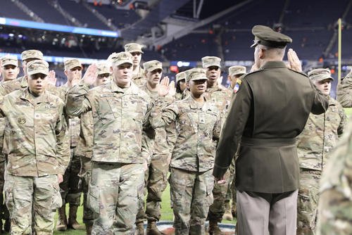 U.S. Army Gen. Andrew Poppas, commander of the U.S. Army Forces Command, performs the oath of enlistment for Army Reserve soldiers assigned to various units in the Chicagoland area before a Chicago Bears Salute to Service game at Soldier Field.