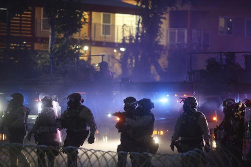 Law enforcement stand during a protest in Compton, California.