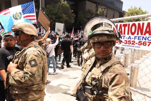 Members of the California National Guard keep an eye out as thousands participate in the &quot;No Kings&quot; demonstration in downtown Los Angeles