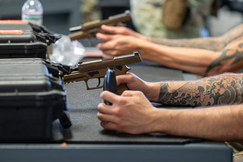 Combat Arms Training and Maintenance students learn how to properly handle M18 pistols at Holloman Air Force Base, New Mexico.