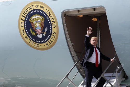 President Trump waves after greeting troops at Joint Base Elmendorf-Richardson