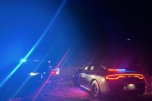 In this photo provided by the Thurston County Sheriff's Office, law enforcement personnel respond to a Wednesday evening, Sept. 17, 2025, helicopter crash near Joint Base Lewis-McChord in Washington state.