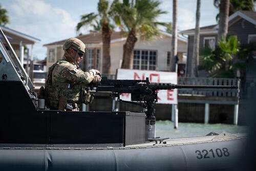 A U.S. Coast Guardsman, a member of Port Security Unit (PSU) 308, mans a Browning M2HB heavy machine gun while on patrol near South Padre Island, Texas, Nov. 2, 2025. PSU 308 was deployed to South Padre Island in support of Operation River Wall, the Coast Guard’s response to increased drug and human trafficking along the Rio Grande River. (U.S. Coast Guard photo by Petty Officer 3rd Class Cheyenne Basurto)