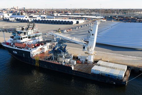 Wind turbine bases, generators and blades are positioned at The Portsmouth Marine terminal along with a support ship at the staging area for Dominion Energy's wind turbine project Monday Dec. 22, 2025, in Portsmouth, Va. (AP Photo/Steve Helber)